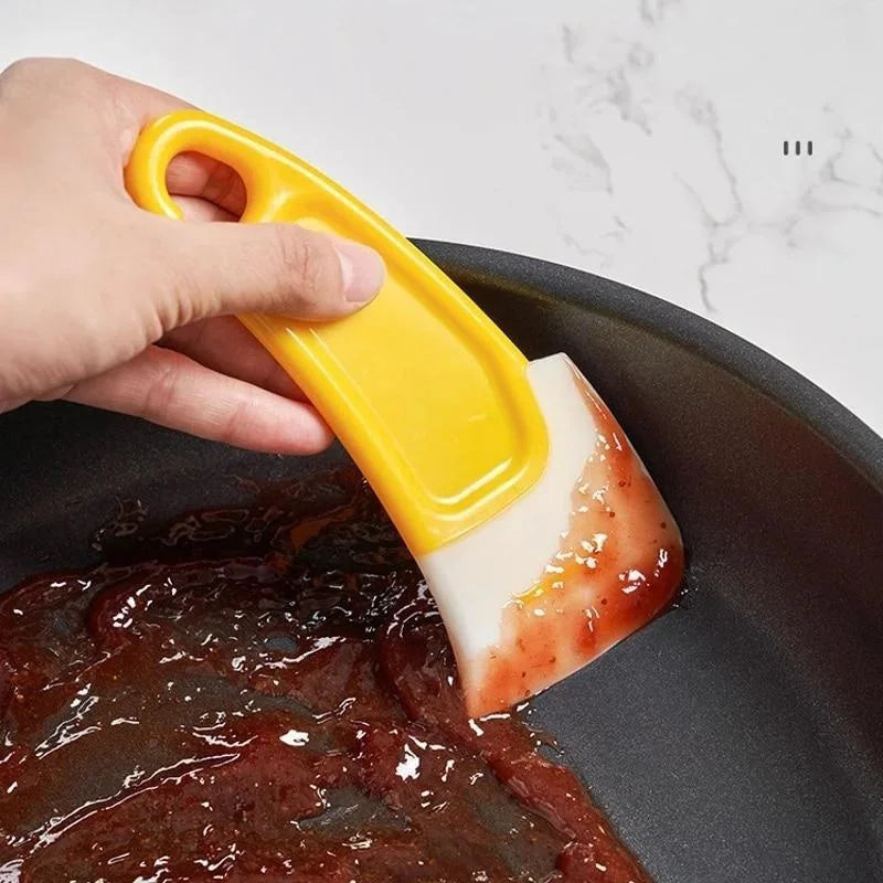 Espátula de silicona para limpieza de utensilios de cocina.